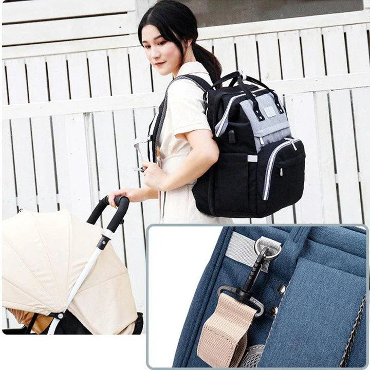 Multifunctional maternity diaper backpack with removable mosquito net, foldable crib, and water-resistant design for convenient family travel