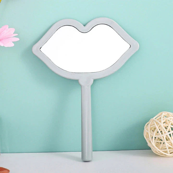 Lip-shaped handheld makeup mirror with a comfortable ergonomic handle for precise on-the-go touch-ups