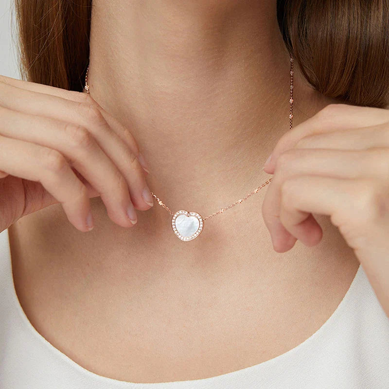 A rose gold or ice silver heart-shaped pendant necklace with an NFC chip for sending personalised digital messages