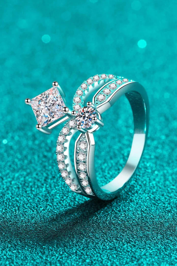 Elegant sterling silver ring with a moissanite centre stone and zircon accents, featuring a modern and minimalist crown design