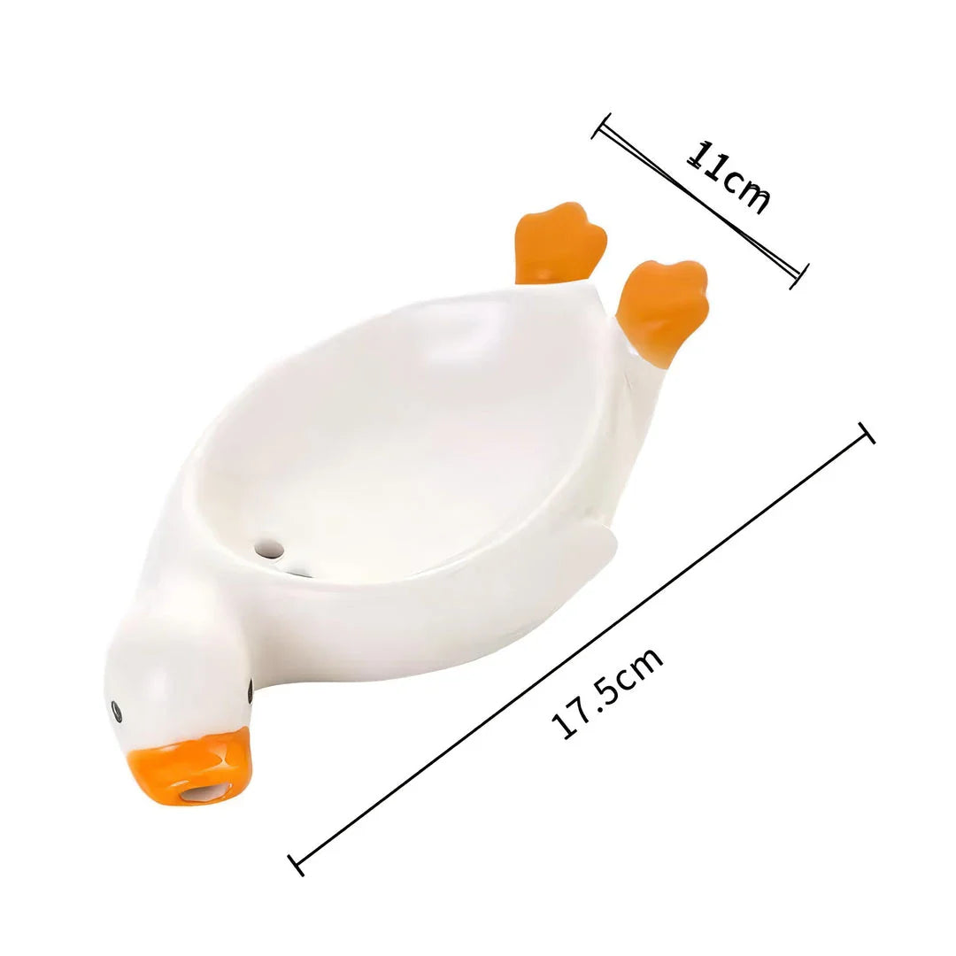 A yellow duck-shaped ceramic soap dish with a drainage system, suitable for modern and traditional British bathrooms.