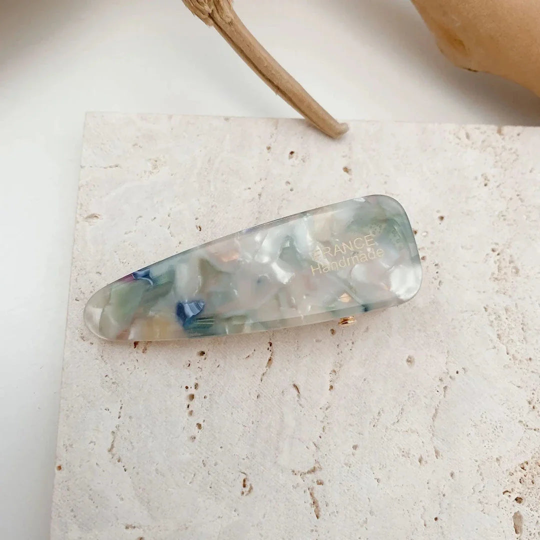 Two marble-patterned hair clips in a contemporary geometric design, made from high-quality acetate and acrylic materials.