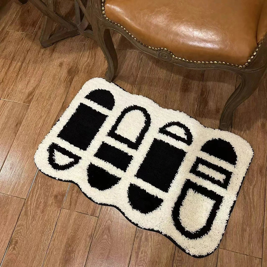 Tufted black and white geometric area rug with a soft, plush texture and anti-slip backing