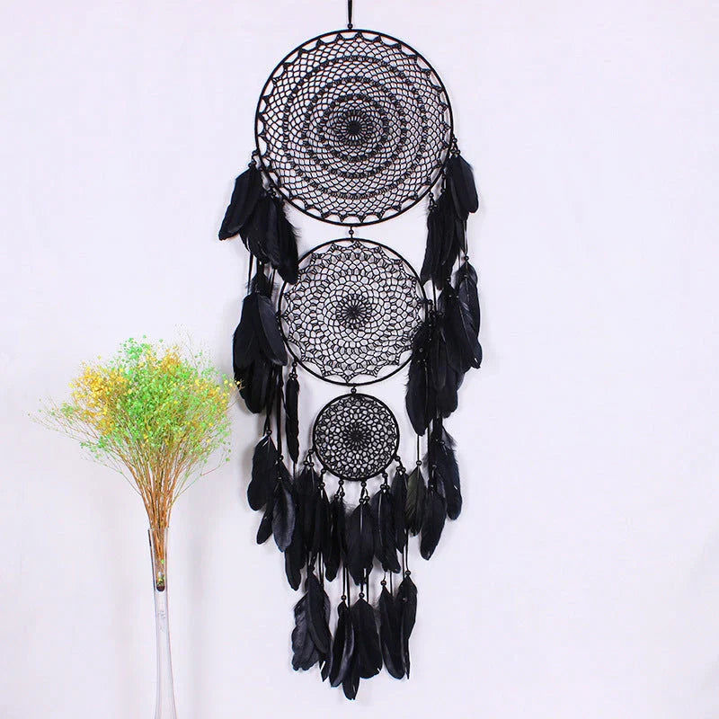 Colourful three-ring dreamcatcher wall hanging with feathers and beads, a unique and eye-catching home decor accent