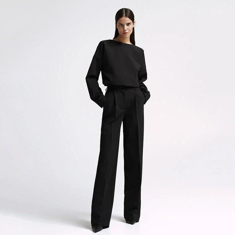 Elegant and sophisticated women's two-piece office suit with long sleeve top and wide-leg pants in a neutral colour palette