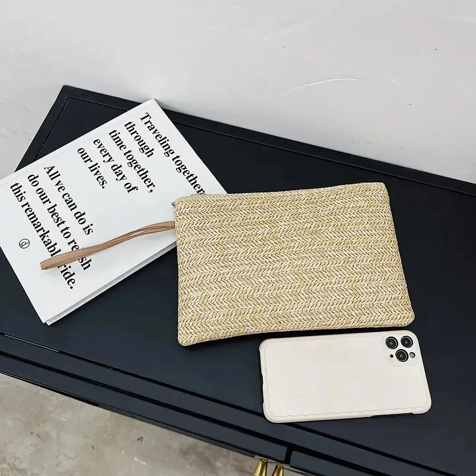 A natural straw-woven clutch with a zipper closure, perfect for summer outings in the UK.