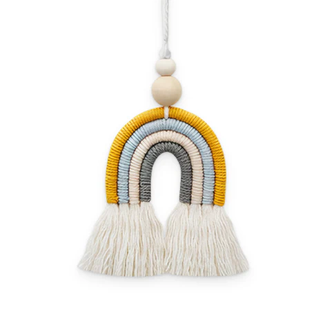 Bohemian-inspired cotton rainbow charm with wooden beads and tassels, a calming and cheerful home decor accent piece