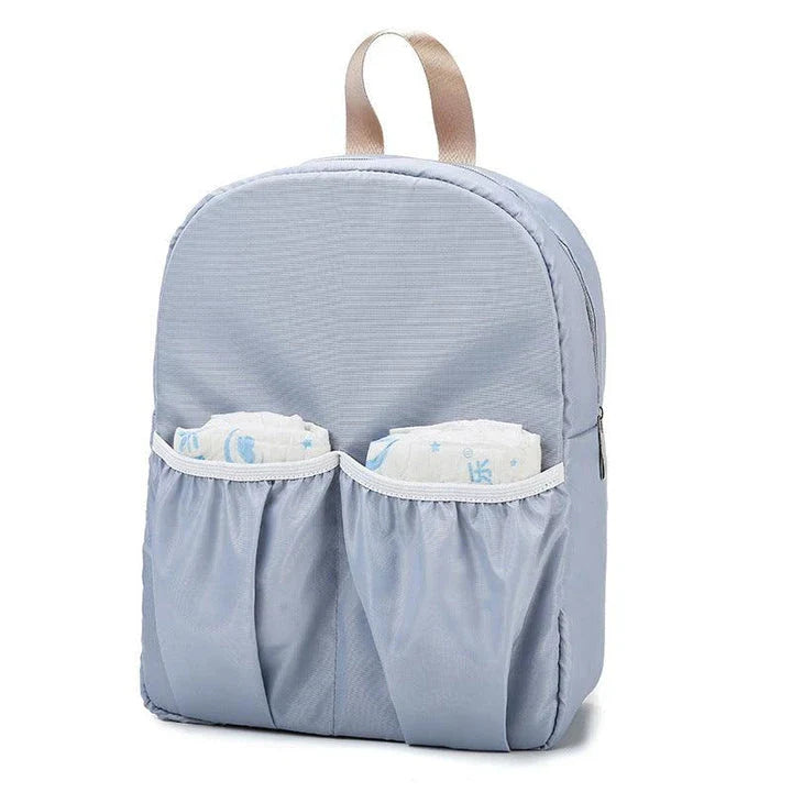 Versatile baby changing backpack with convertible crib bed, large storage capacity, and insulated feeding bottle compartment