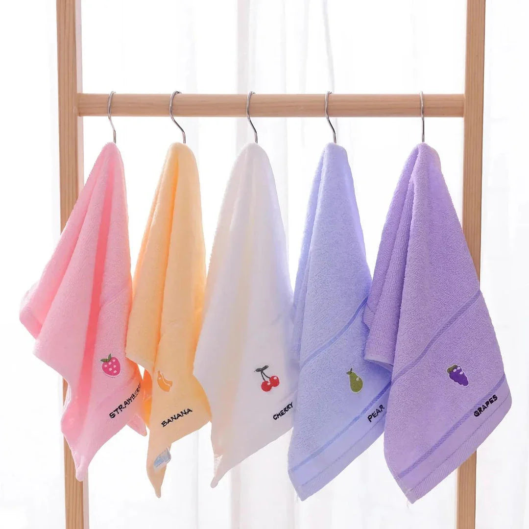 Soft cotton baby bath towel with adorable cartoon fruit face designs in pink
