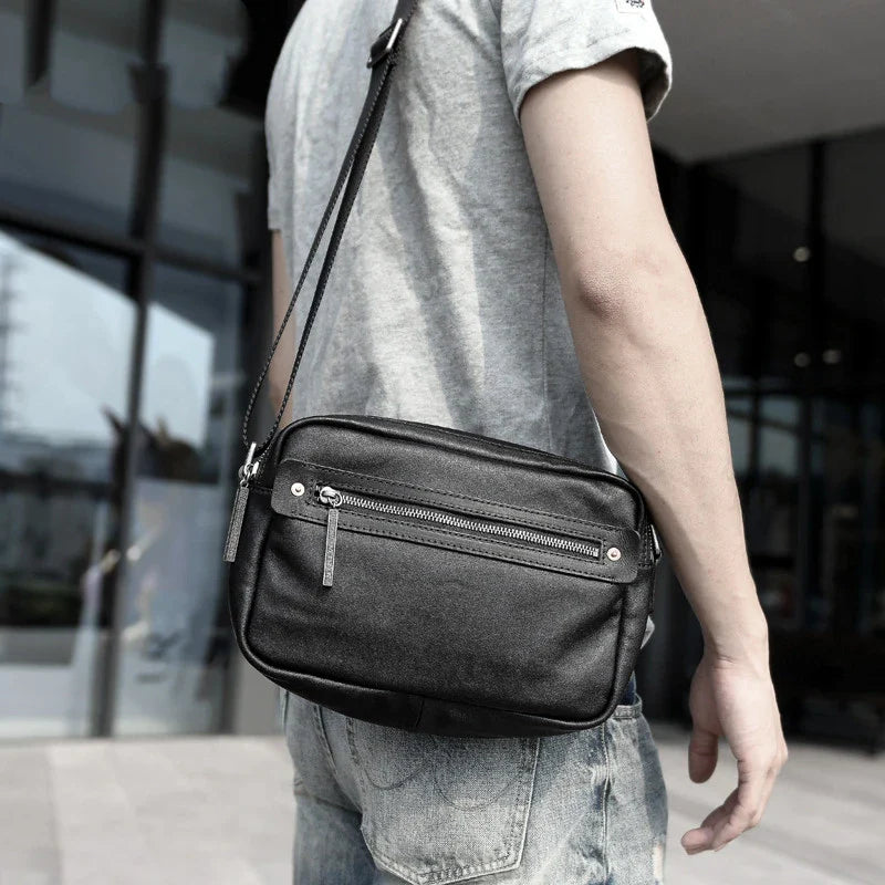 A premium British leather shoulder bag with a sleek, minimalist design and adjustable strap