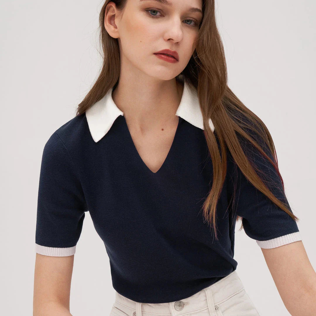 Stylish silk knit polo shirt in navy blue, featuring a slim fit design, contrasting trim, and a feminine v-neckline for refined British elegance.