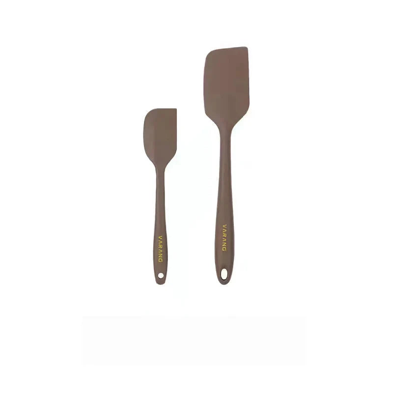 A set of two high-quality silicone spatulas in brown and yellow colours, designed for versatile cooking and baking tasks.