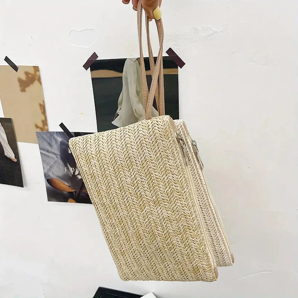 A natural straw-woven clutch with a zipper closure, perfect for summer outings in the UK.