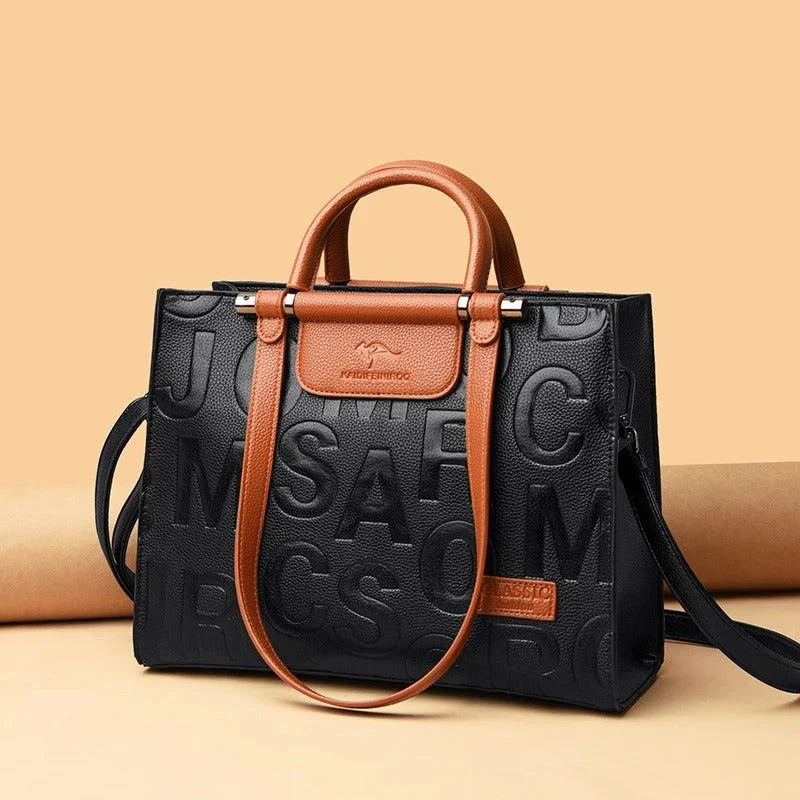 Sophisticated large leather tote bag with embossed lettering design, suitable for daily use and travel