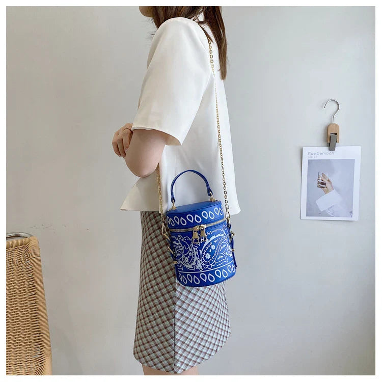 Premium PU leather bucket bag in a variety of classic and contemporary colours, featuring a spacious main compartment, adjustable shoulder strap, and sophisticated British-inspired design.