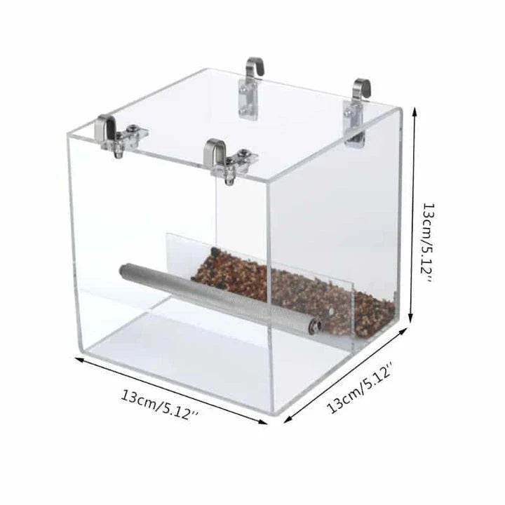 A transparent acrylic bird feeder cube with a sleek and modern design, perfect for adding a touch of elegance to your garden or balcony.
