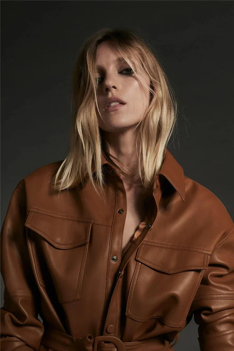 Stylish British-made faux leather jacket with stitching details and adjustable belt for a customized fit
