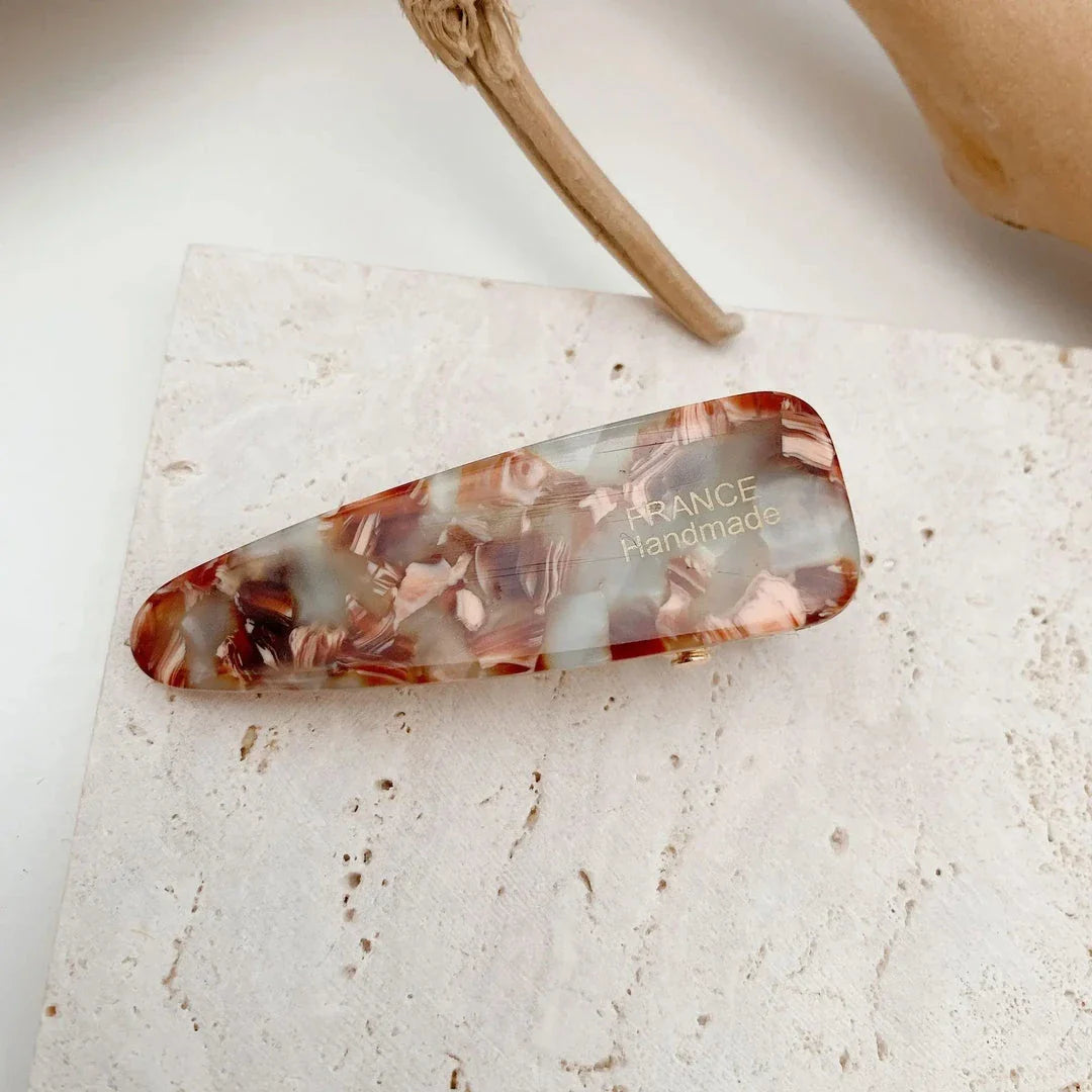 Two marble-patterned hair clips in a contemporary geometric design, made from high-quality acetate and acrylic materials.