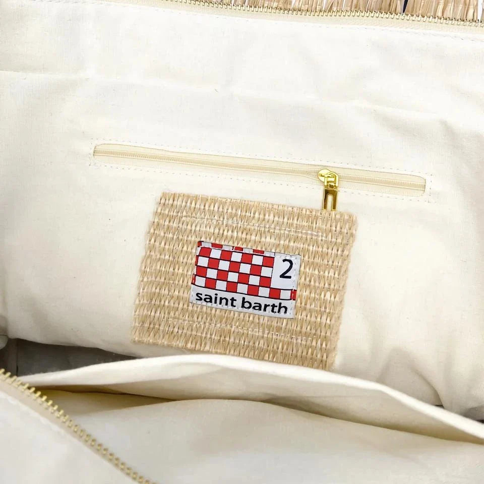Stylish embroidered straw tote bag with playful tassels, perfect for summer outings and beach adventures.
