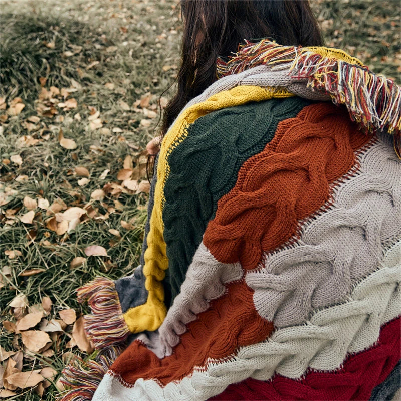 Elegant wool blanket with stylish plaid pattern and fringed tassels, perfect for cosy home decor and outdoor adventures.