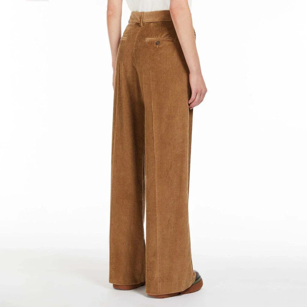 A pair of high-waist, wide-leg corduroy trousers in a classic red colour, designed for the modern British woman's wardrobe.