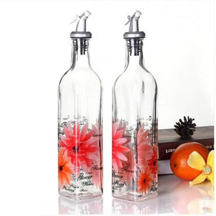 Ethnic-inspired glass bottles with handpainted floral designs, offering stylish storage for sauces, oils, and spices