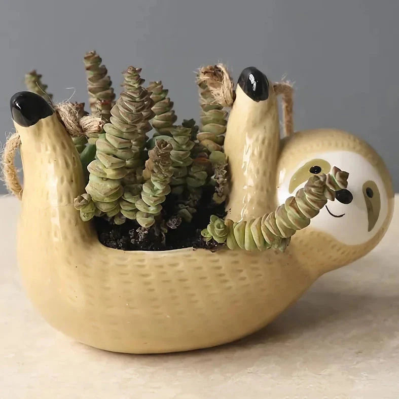 Ceramic hanging planter with a whimsical cartoon animal design, available in grey or yellow, for adding a touch of nature and playfulness to indoor spaces.