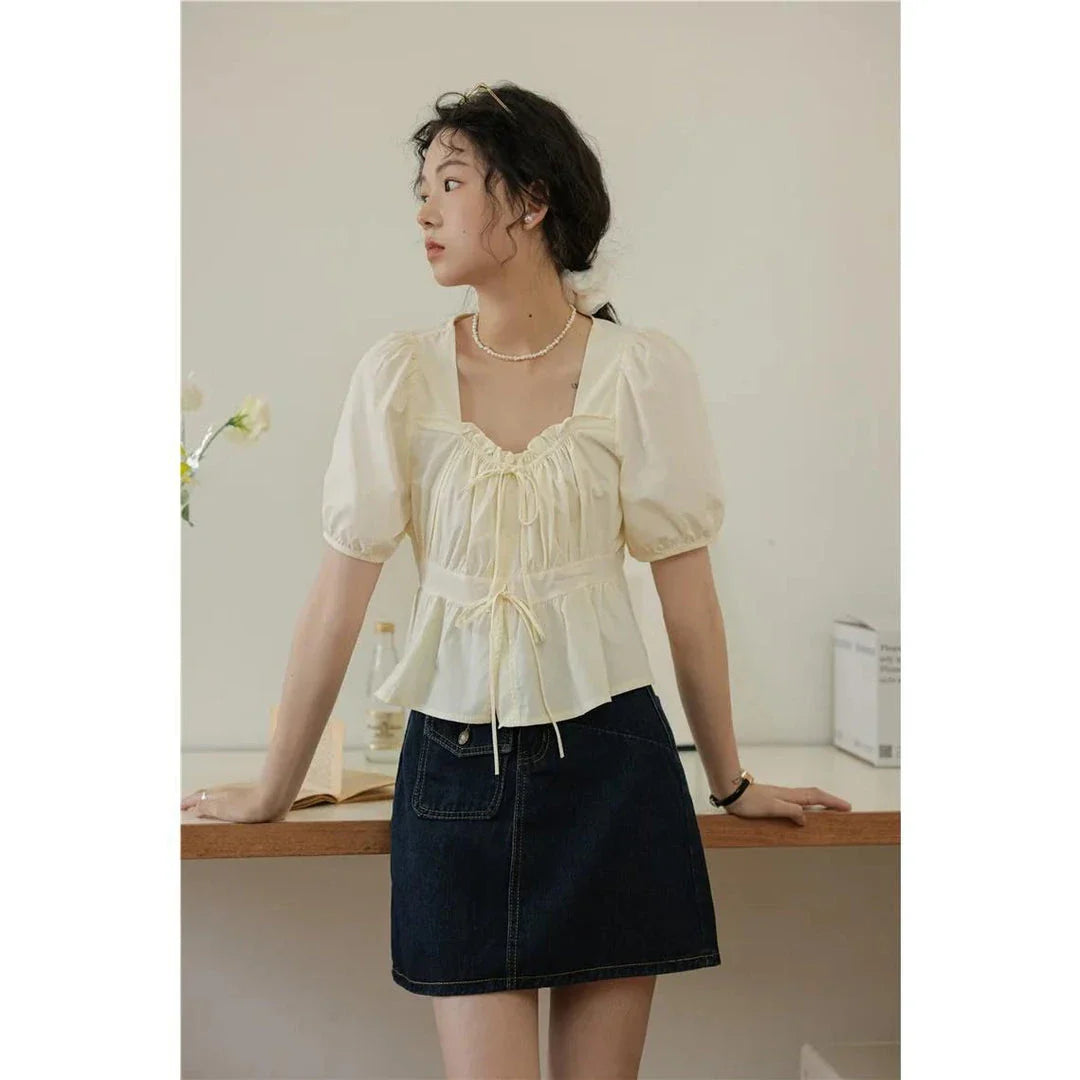 Elegant vintage square neck puff sleeve blouse in white with lace-up detail and puff sleeves