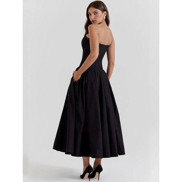Elegant, backless A-line midi dress in black for women, featuring a sleek silhouette and sophisticated draping