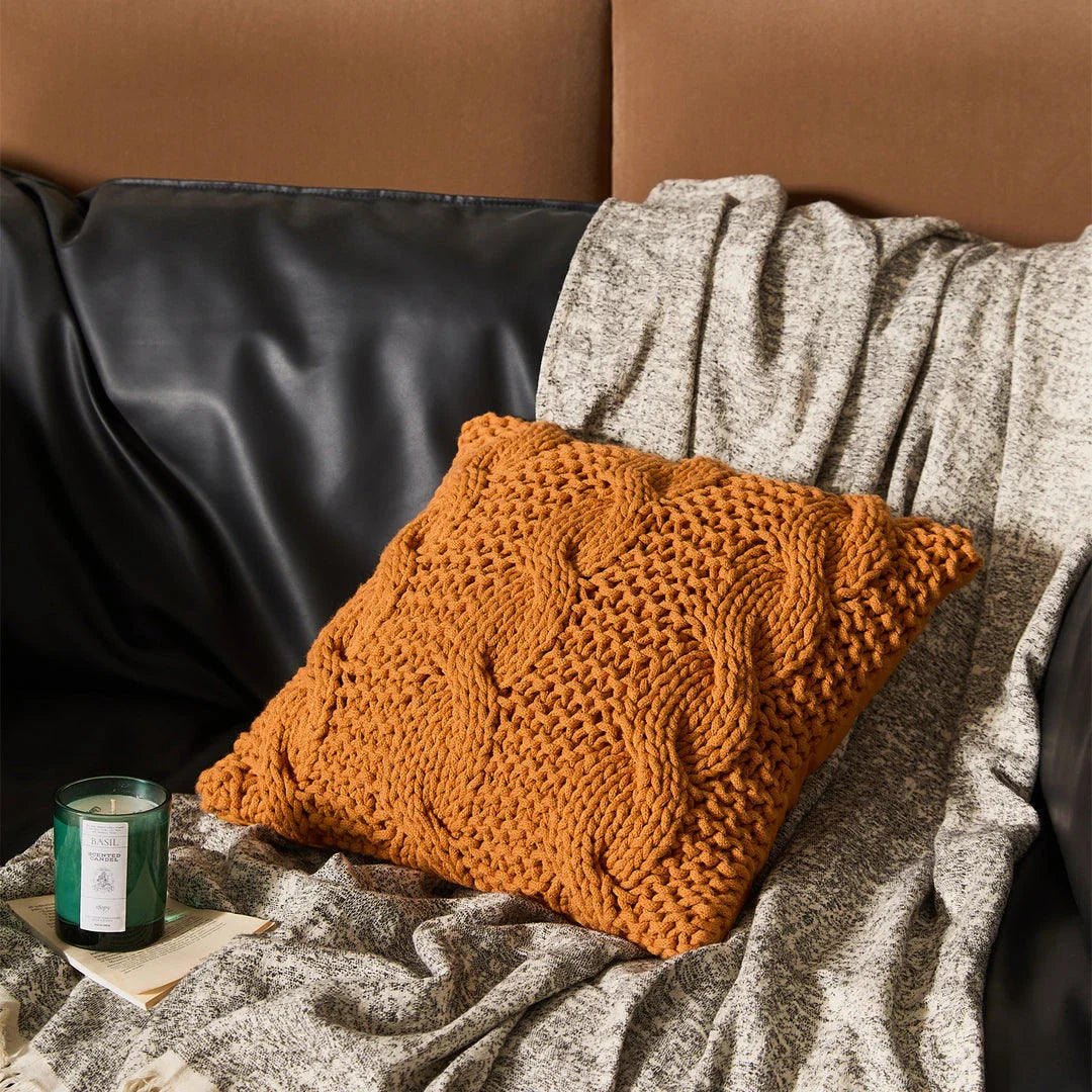 Luxurious hand-crocheted chunky knit throw pillow in a range of vibrant colours, providing cosy comfort and sophisticated style.