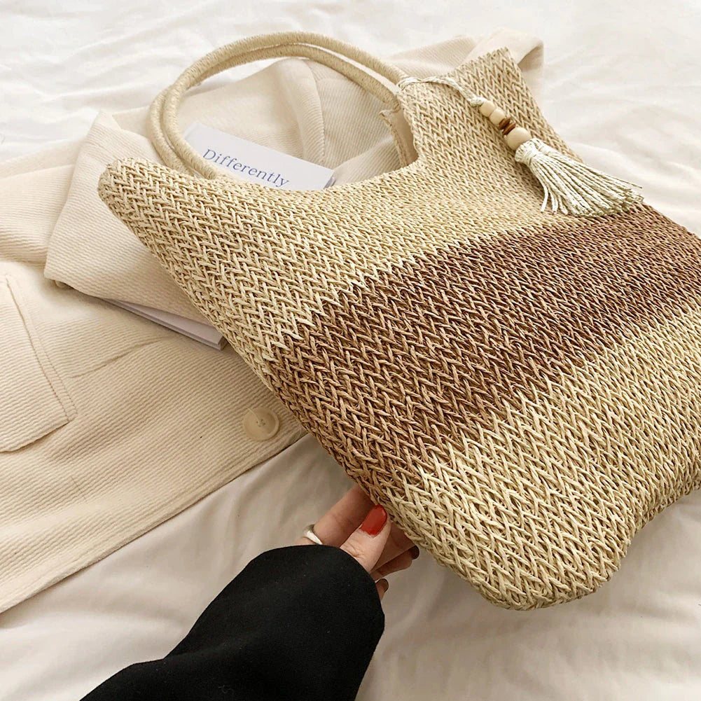 Stylish bohemian-inspired woven tote bag with contrasting tassels, perfect for summer outings