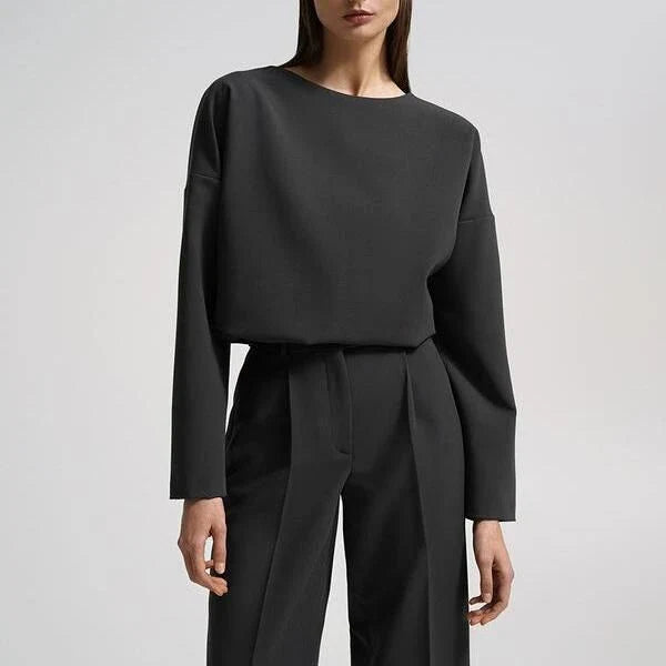 Elegant and sophisticated women's two-piece office suit with long sleeve top and wide-leg pants in a neutral colour palette