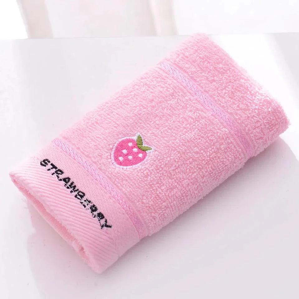 Soft cotton baby bath towel with adorable cartoon fruit face designs in pink