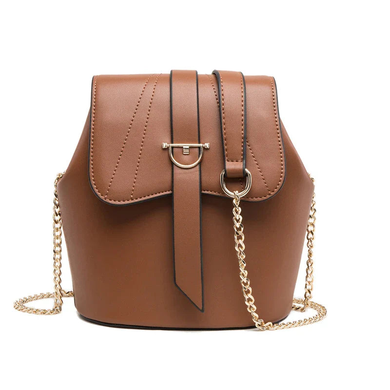 A large capacity chain bag with a classic bucket silhouette, crafted from premium leather-look material for sophisticated British style.