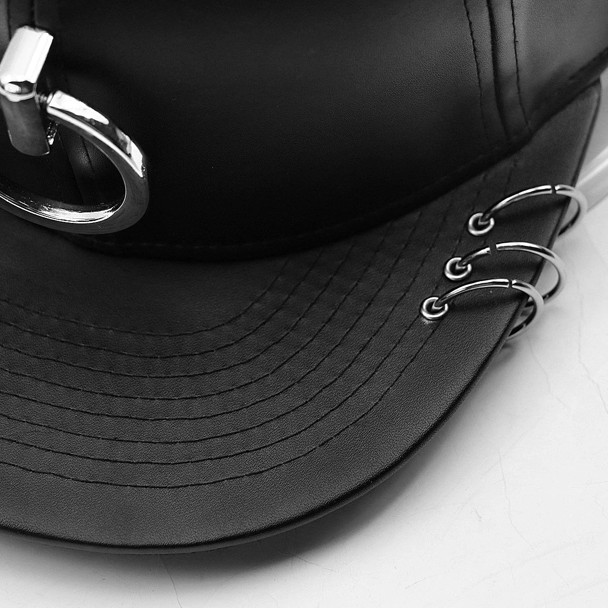 A stylish black flat-brimmed cap with a Korean-inspired design, featuring an adjustable elastic band for a comfortable fit.