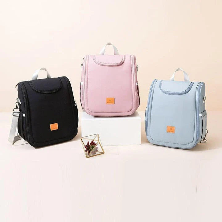 Versatile baby changing backpack with convertible crib bed, large storage capacity, and insulated feeding bottle compartment