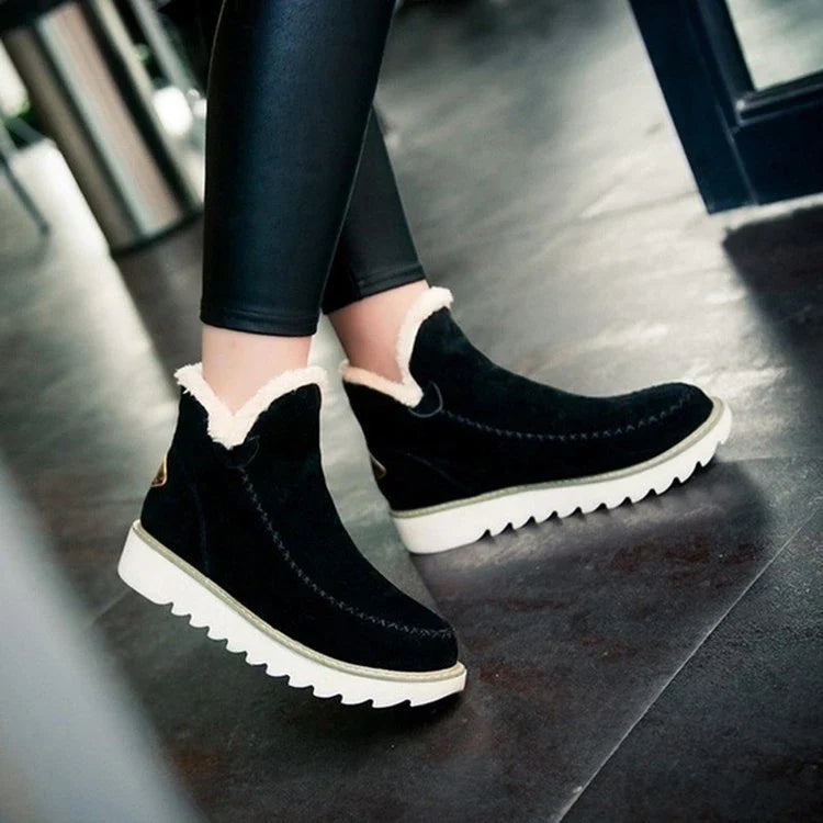 A pair of stylish, non-slip snow boots with a warm artificial wool lining, perfect for British winter weather