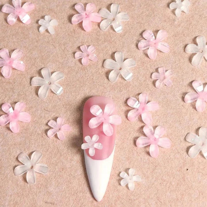 Elegant 3D flower nail charms in white and pink colours, featuring a transparent jelly finish and rhinestone accents for a stylish manicure