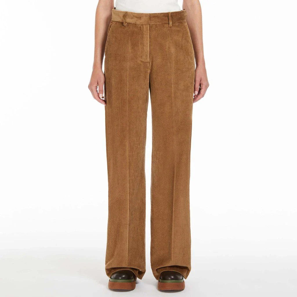 A pair of high-waist, wide-leg corduroy trousers in a classic red colour, designed for the modern British woman's wardrobe.