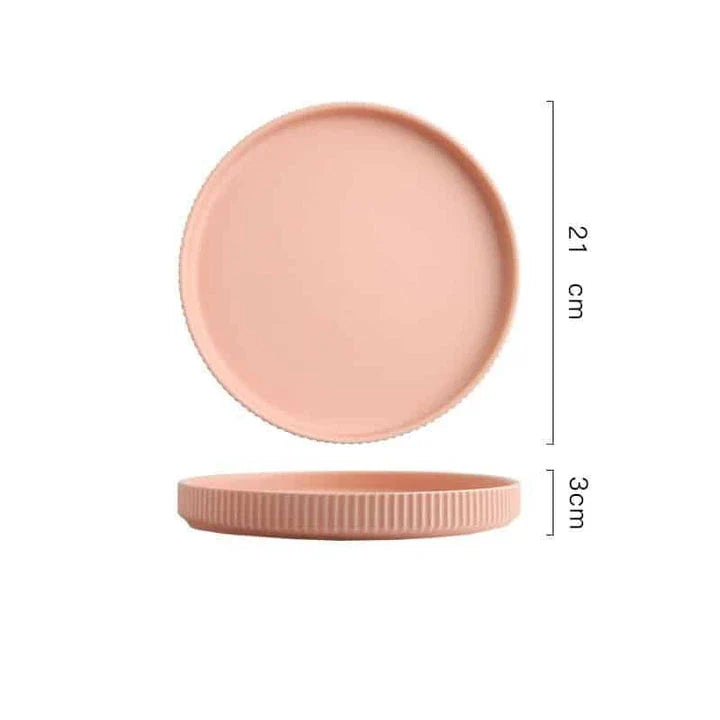 Candy-coloured ribbed ceramic tableware featuring plates, bowls, and other dining accessories in vibrant hues