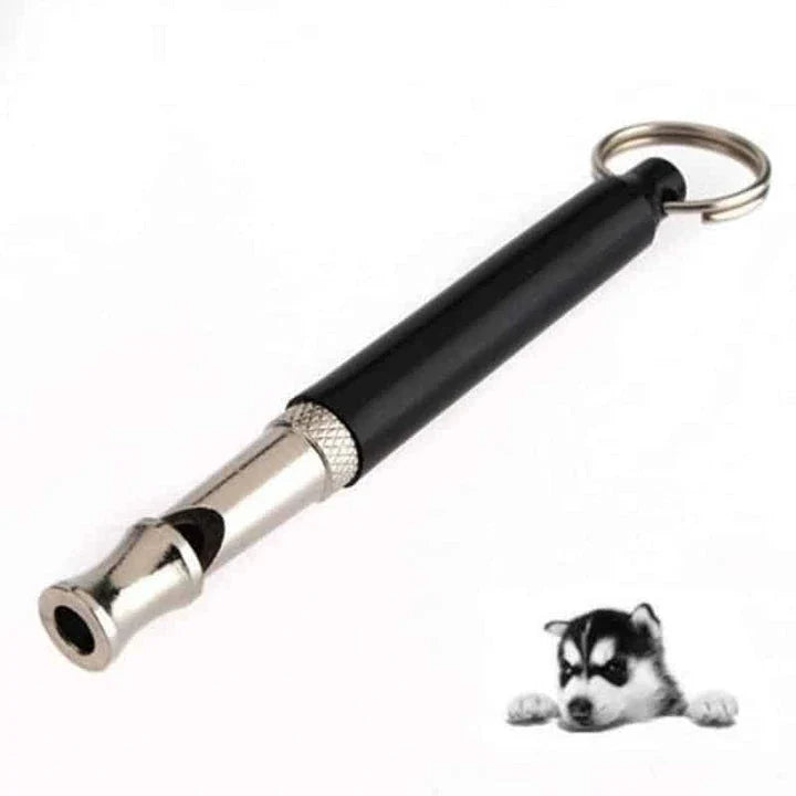Compact ultrasonic dog training whistle in black and silver color, with a keyring loop for easy attachment