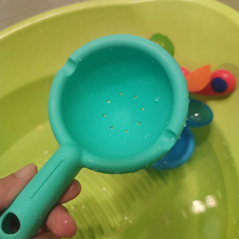 Colourful children's bath toy with a turning windmill and spoon for imaginative water play