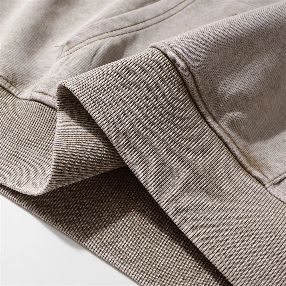 Embroidered cotton hoodie with a letter patch design, available in brown, grey, and black colours and sizes S to XL