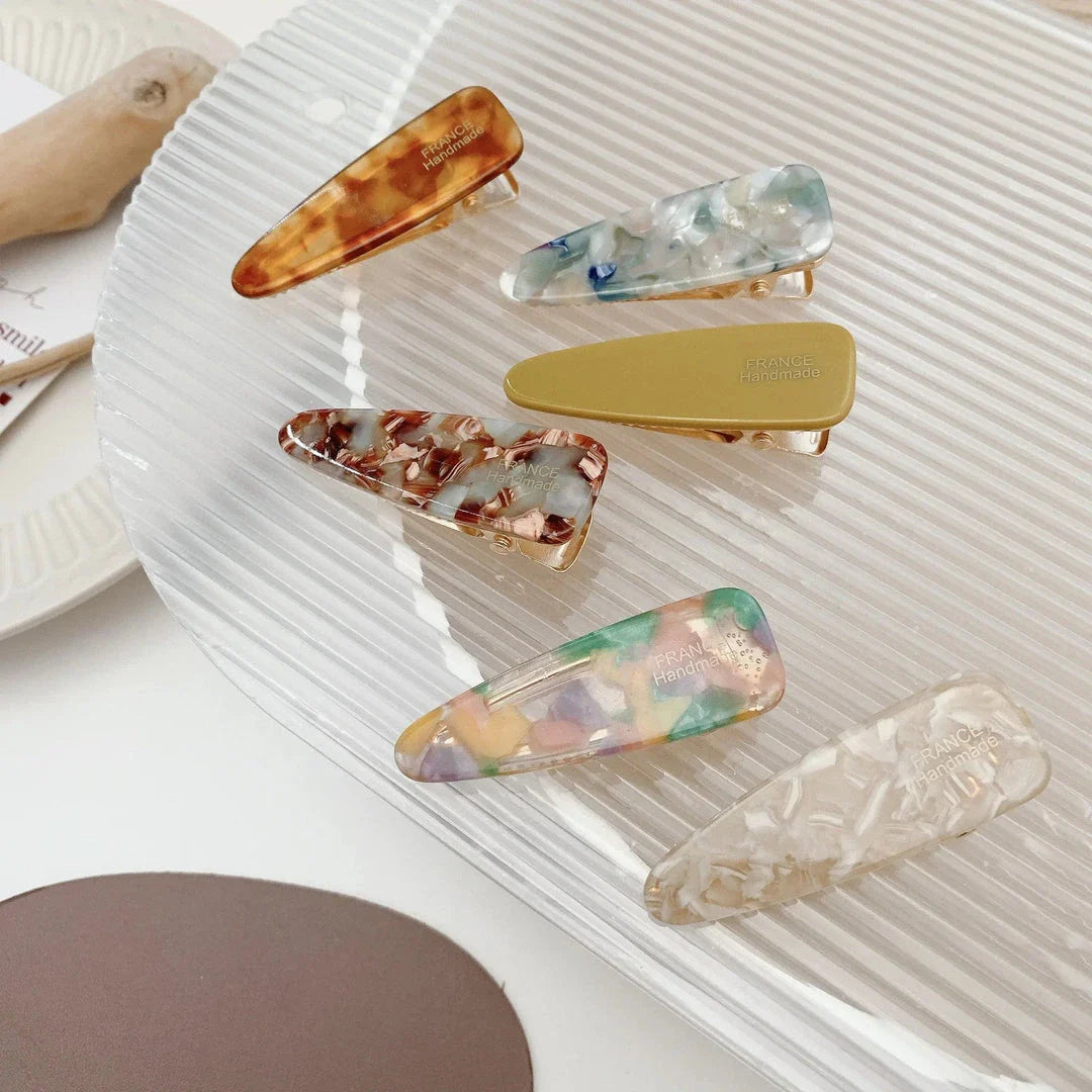 Two marble-patterned hair clips in a contemporary geometric design, made from high-quality acetate and acrylic materials.