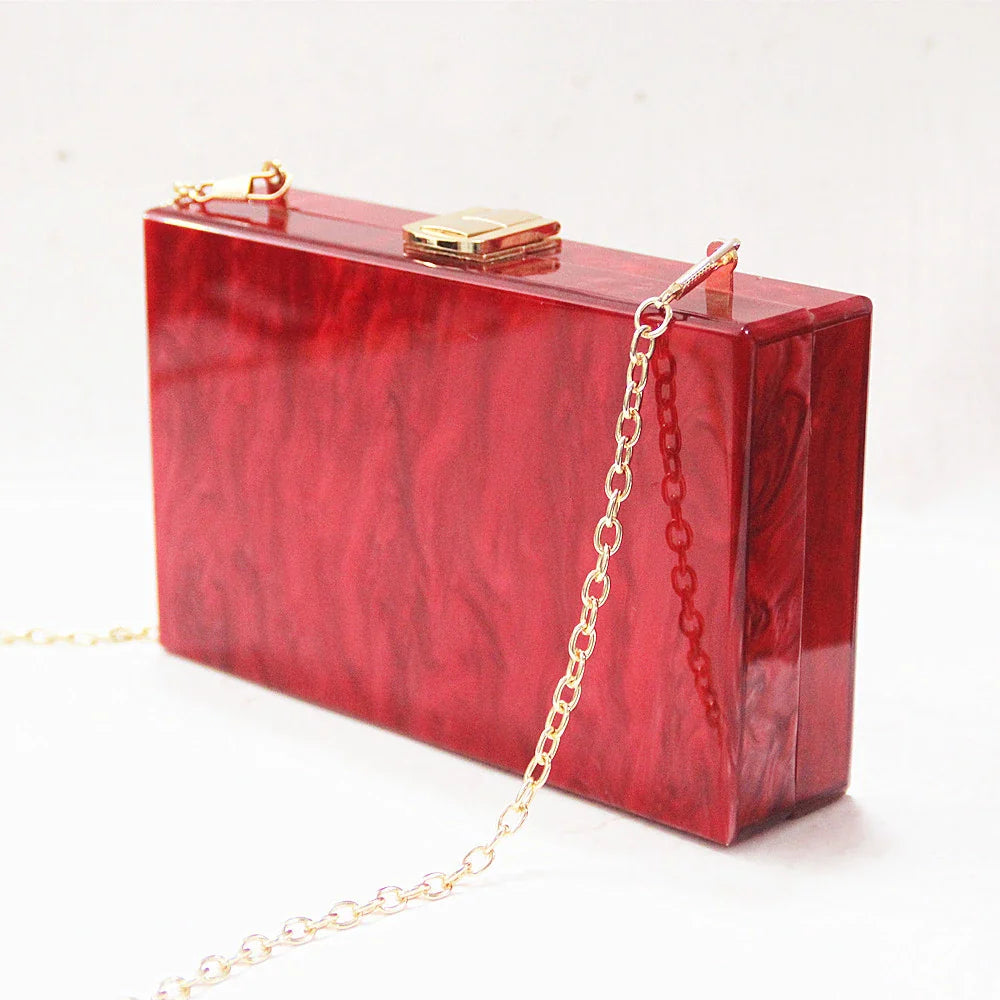 Stylish pearlescent acrylic clutch bag in red colour with a structured, square-shaped design