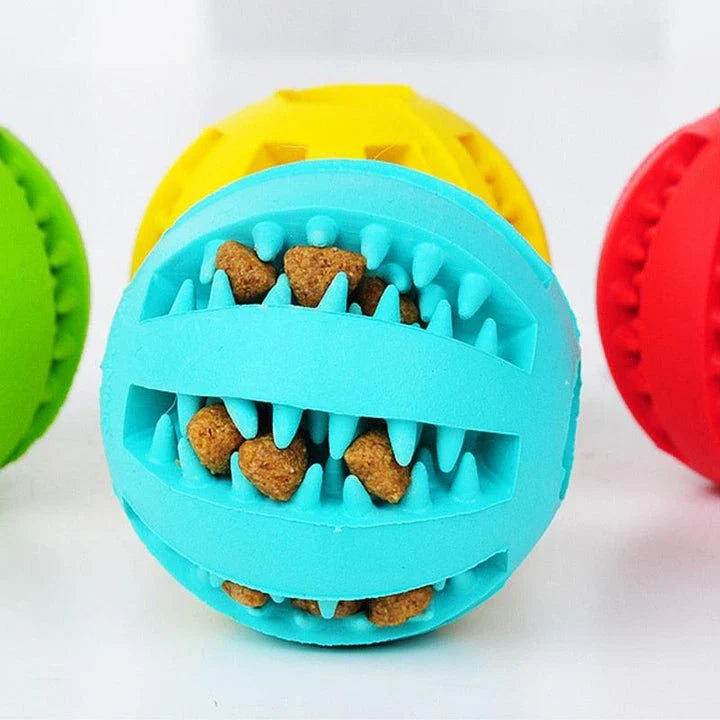 Premium natural rubber interactive ball for dogs in various colours, designed to provide mental stimulation and physical exercise.