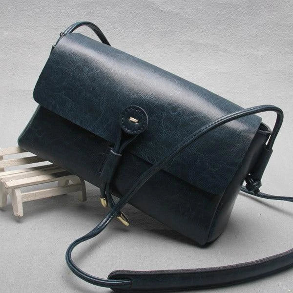 Premium leather crossbody bag in a sleek, horizontal square design with subtle car stitching details