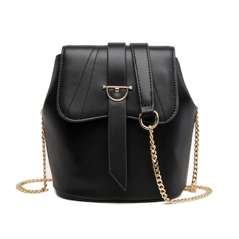 A large capacity chain bag with a classic bucket silhouette, crafted from premium leather-look material for sophisticated British style.