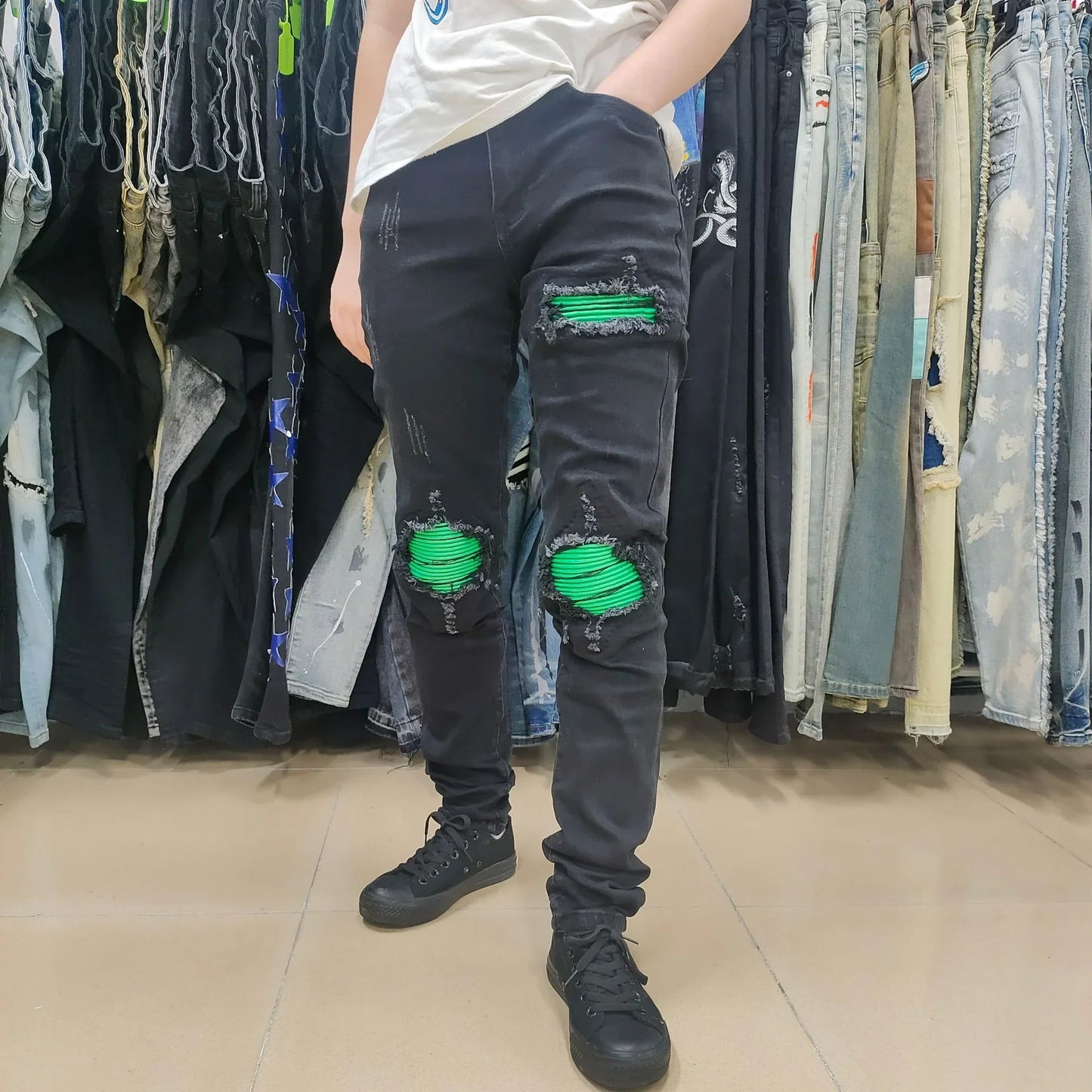 Premium ripped black jeans with stylish green patchwork design, made with medium-elastic fabric for comfort and a slim, flattering silhouette.