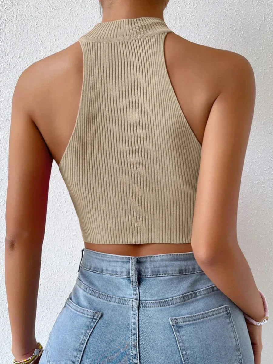 A stylish knitted camisole top in beige and peacock blue colours, featuring a slim-fit design and exposed navel detail for a trendy British fashion look.
